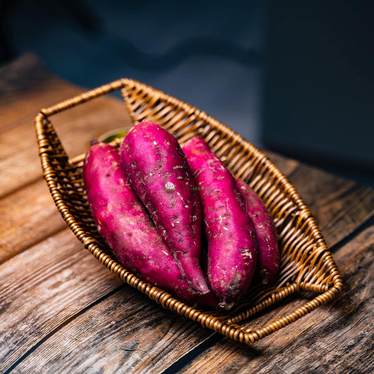 Four purple sweet potatoes on a basket - fresh and vibrant. A nutritious root vegetable rich in antioxidants