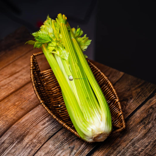 Fresh English celery on a wooden surface