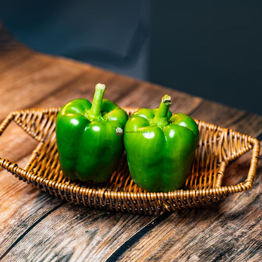  Green bell pepper with stem on a wooden basket