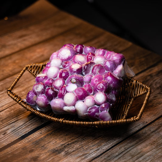 A packet of peeled shallots on a wooden basket. Shallots are a type of onion with a mild, sweet flavor. They are often used in cooking.