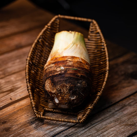 Thai white yam on basket, wood surface. Plump, white, and textured root vegetable.