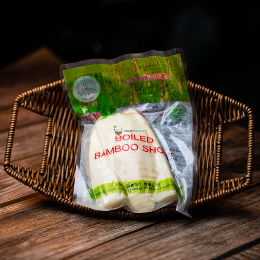 A packet of boiled bamboo shoots on a wooden basket. The shoots are white and crunchy, with a slightly sweet flavor. They are a popular ingredient in Asian cuisine.
