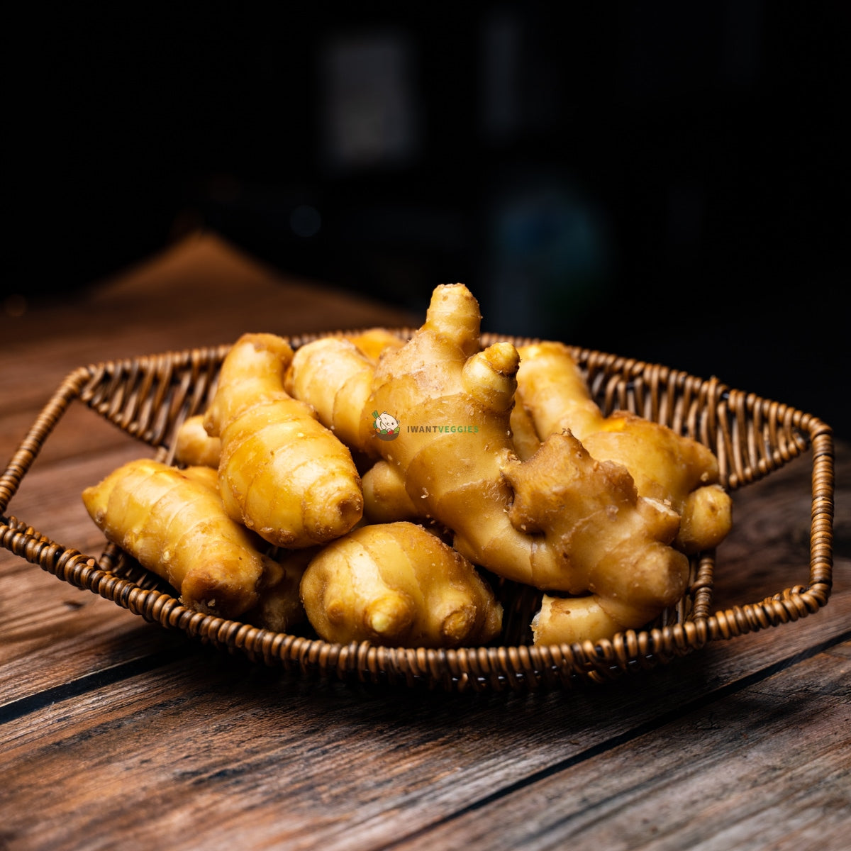 Basket of aged ginger on wooden surface. Brown, wrinkled skin with fibrous texture.